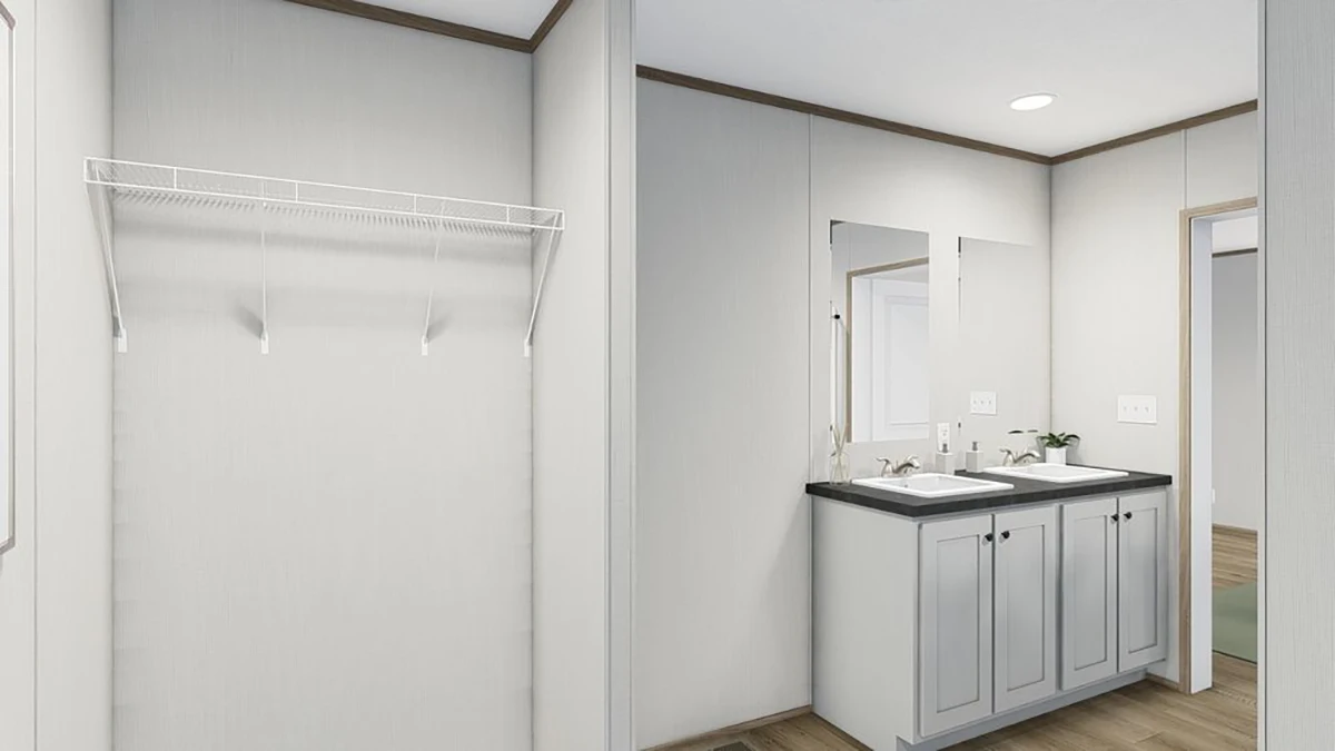A bathroom with a double sink vanity, two mirrors, light gray cabinets, and an empty wall-mounted wire shelf on the left.