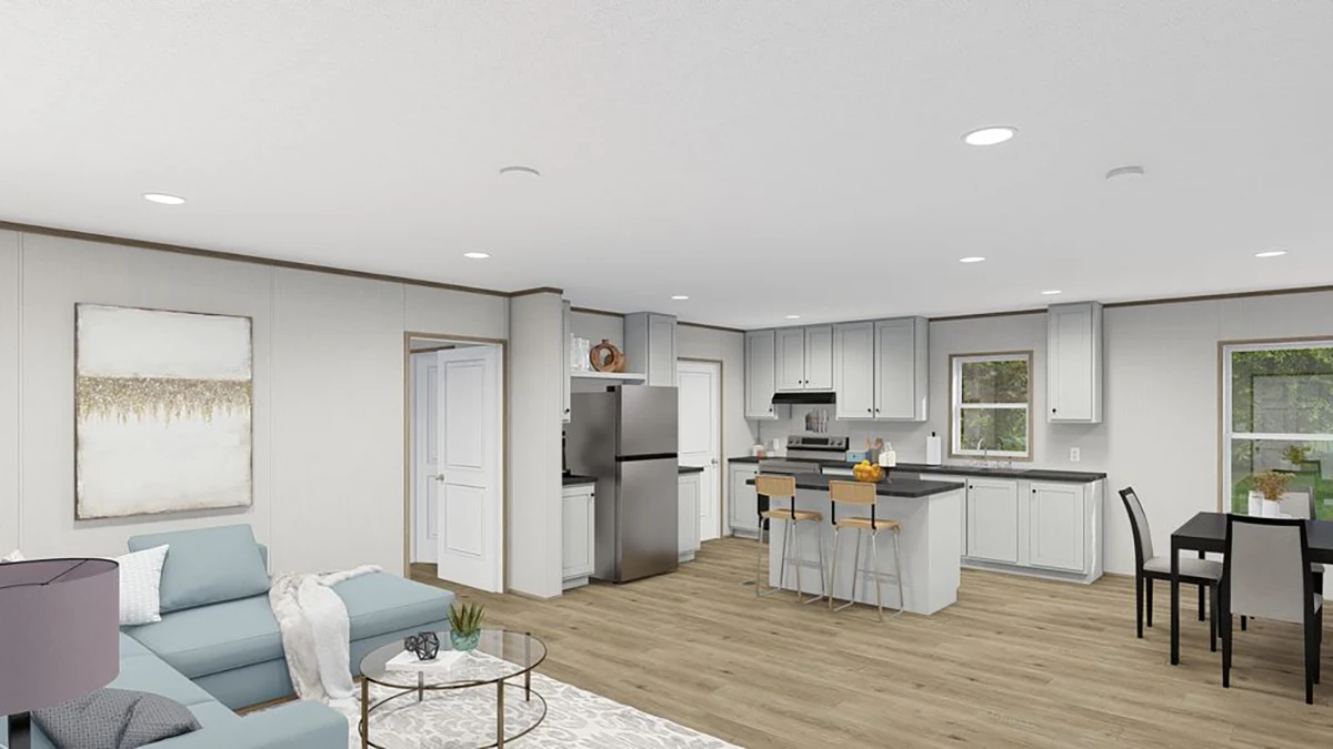 Open-plan living area with light wood flooring, a blue sofa, glass coffee table, modern kitchen with island, stainless steel appliances, and a dining table by the window.