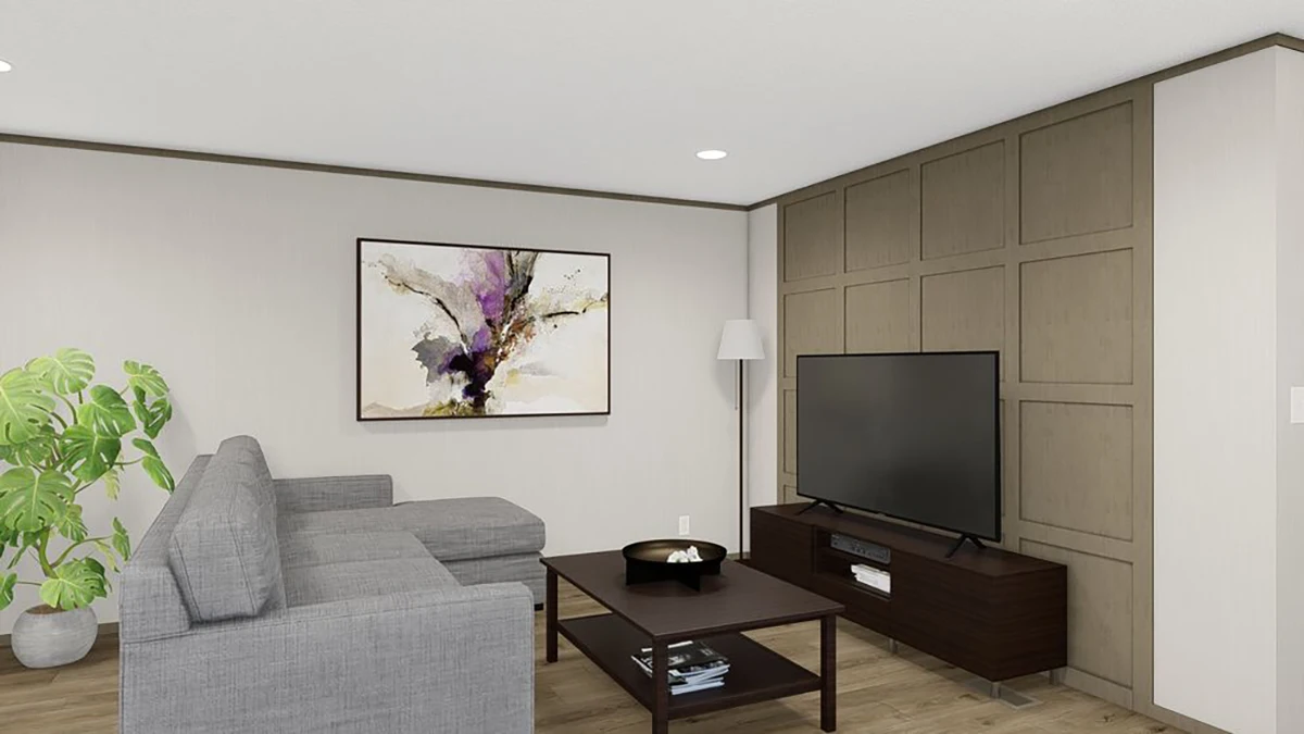 A modern living room with a gray sectional sofa, a TV on a dark wood stand, a coffee table, a floor lamp, a potted plant, and abstract art on the wall.