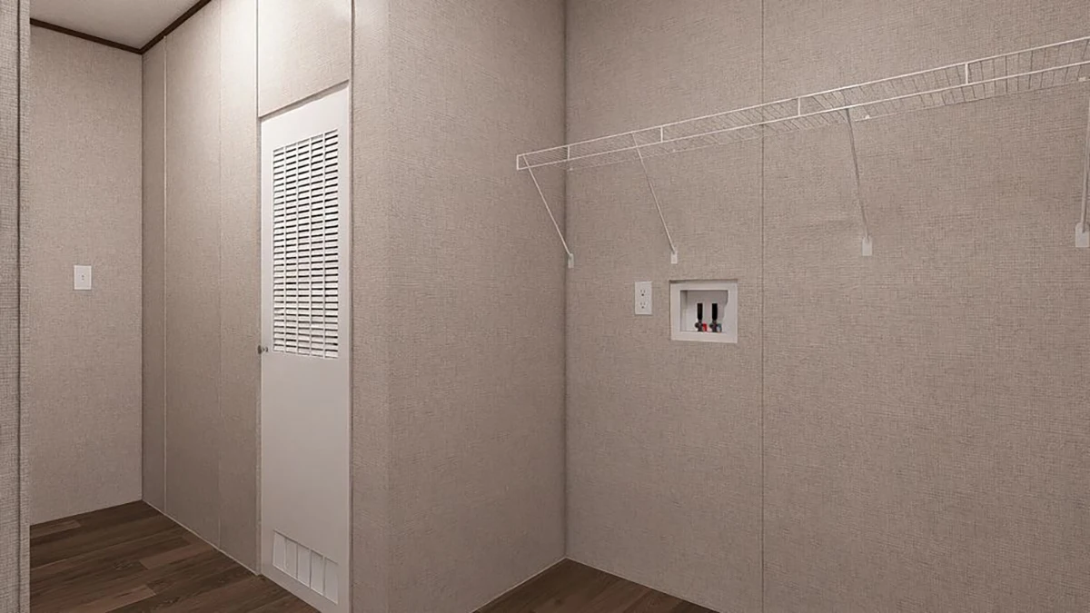 Empty laundry room with beige walls, wooden floor, a wire shelf, a utility hookup box, and a vented door.