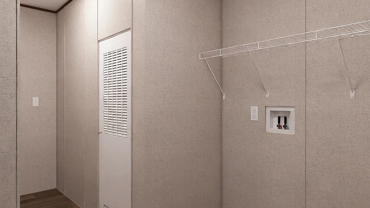 A small laundry room with beige walls, a white louvered door, a wire shelf, and washer and dryer hookups on the wall.