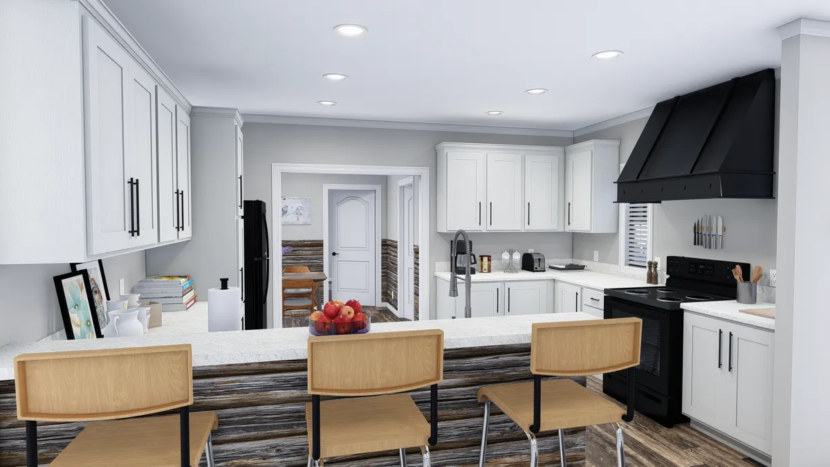 fca9356d-7054-4b9b-9a20-8848cb0f7290 Modern kitchen with white cabinets, black appliances, a breakfast bar with wooden stools, and fruit bowl on the counter; view extends to a dining area through a doorway.