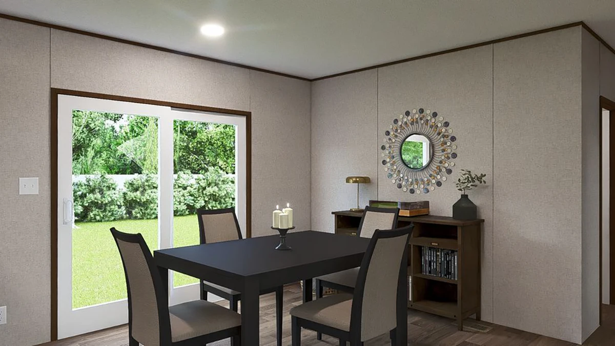 fede6aac-3044-487a-9c84-7e244e2bf035 A modern dining area with a square black table, four chairs, a candle centerpiece, and a bookshelf against the wall, with glass doors showing a green yard outside.