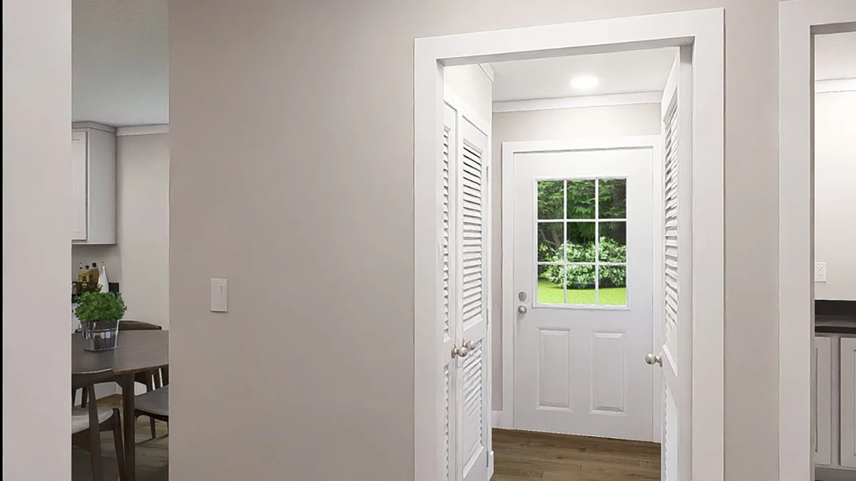 ffb9389b-77f8-4d78-9a2f-7c44b59d677d A white door with glass panels leads to a grassy backyard, viewed from inside a home with light-colored walls and wood flooring.