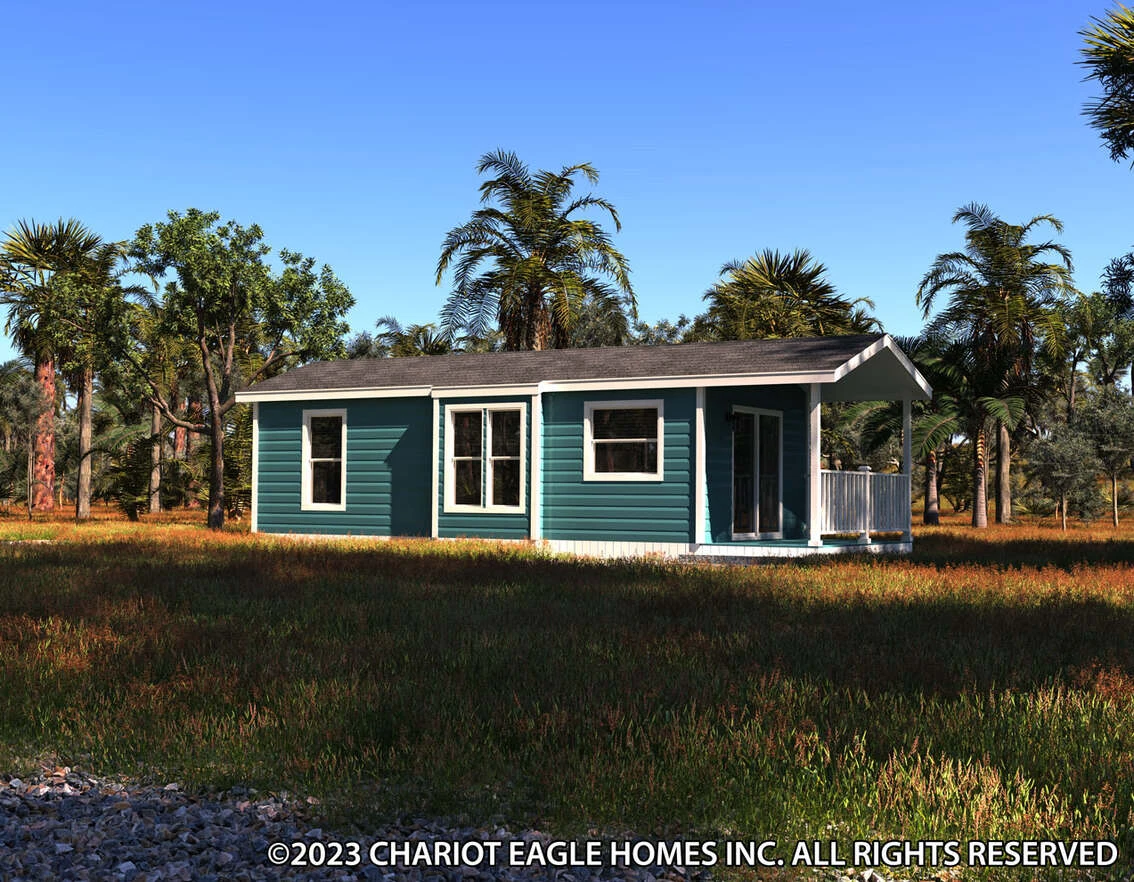 36ee13291a_rf0_1691777662319_1134_12 A small, blue manufactured home with a covered porch sits in a grassy field surrounded by palm trees under a clear sky.