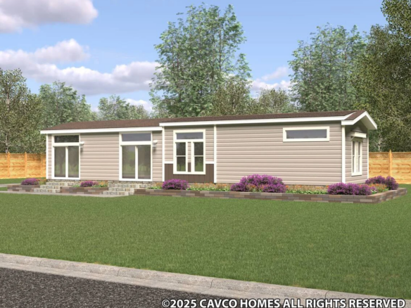 Single-story modern manufactured home with tan siding, large windows, a small front garden, and a wooden fence in the background.