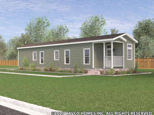 A single-story, green manufactured home with a small covered porch, white trim, and landscaped yard on a grassy lot.