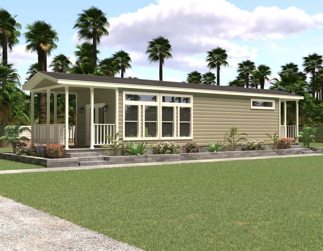 A modern single-story tiny house with beige siding, large windows, and a covered porch, surrounded by landscaped plants and palm trees.