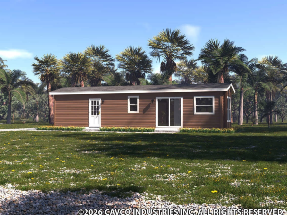 Single-story brown manufactured home with white trim, surrounded by grass, palm trees, and a clear blue sky. ©2026 Cavco Industries Inc. All rights reserved.