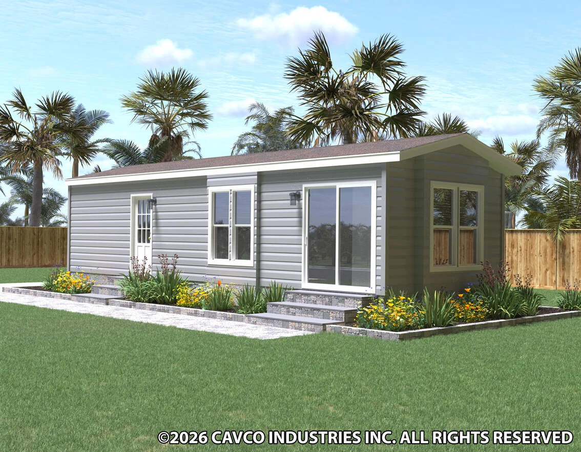 36hk13381c_rf0_1134_12 A modern single-story modular home with gray siding, large windows, and a landscaped yard with stone steps, surrounded by a wooden fence and palm trees.