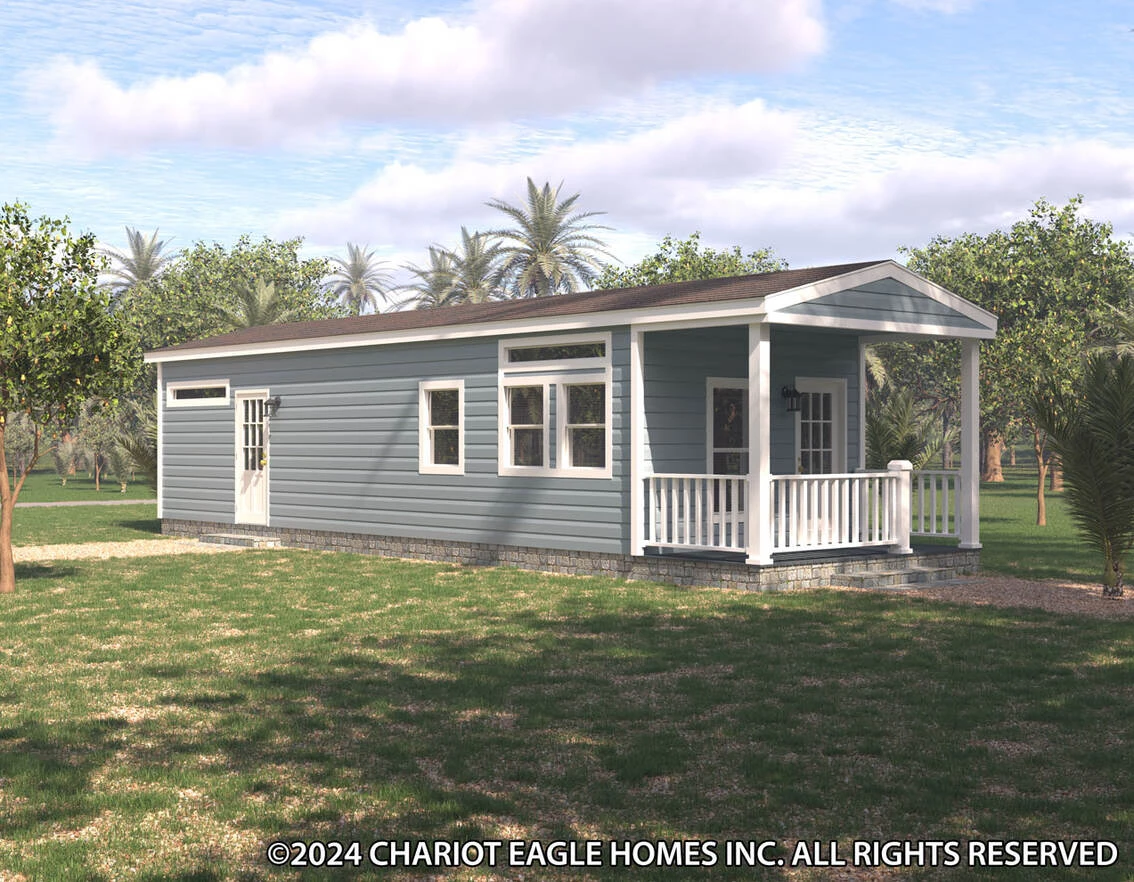 36hk13382a_rf0_1_1742592120485_1134_12 A small blue manufactured home with white trim and a covered front porch, surrounded by trees and grass under a partly cloudy sky.