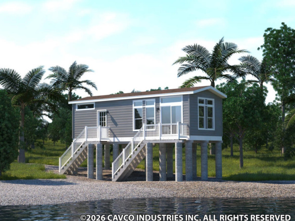A small gray house on stilts stands by the water, surrounded by palm trees, with a staircase leading up to the porch.
