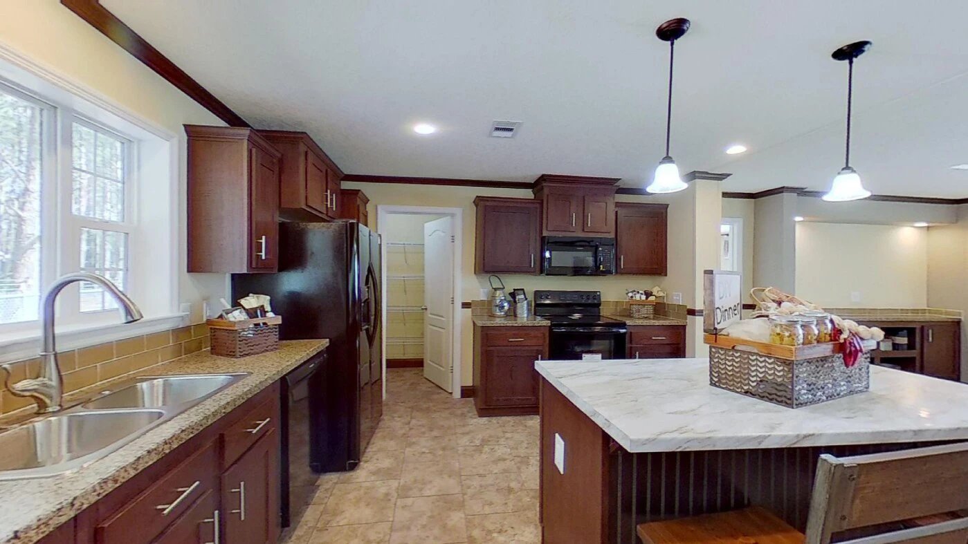 Modern kitchen with dark wood cabinets, stainless steel appliances, center island with marble countertop, double sink, tiled floor, and pendant lighting.