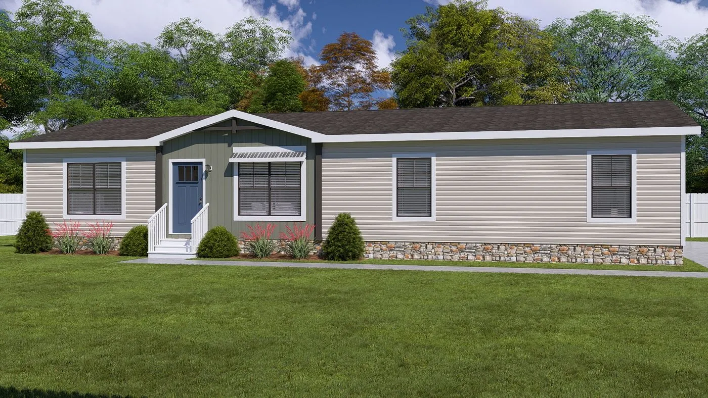 Isabel Elite01 Single-story manufactured home with beige siding, stone trim, white-framed windows, and small shrubs in front yard, set against a backdrop of trees and blue sky.