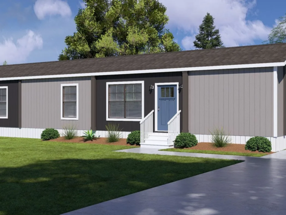A single-story, gray manufactured home with white trim, a small front porch, and steps, surrounded by a green lawn and shrubs, with trees and a driveway nearby.