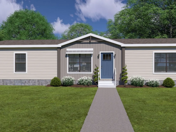 A beige and gray single-story manufactured home with a blue front door, three front windows, small shrubs, and a concrete walkway, set against a background of green trees and blue sky.