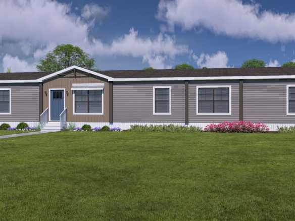 A single-story, gray manufactured home with white trim, multiple windows, a front door with steps, and a well-kept lawn with shrubs and flowers.