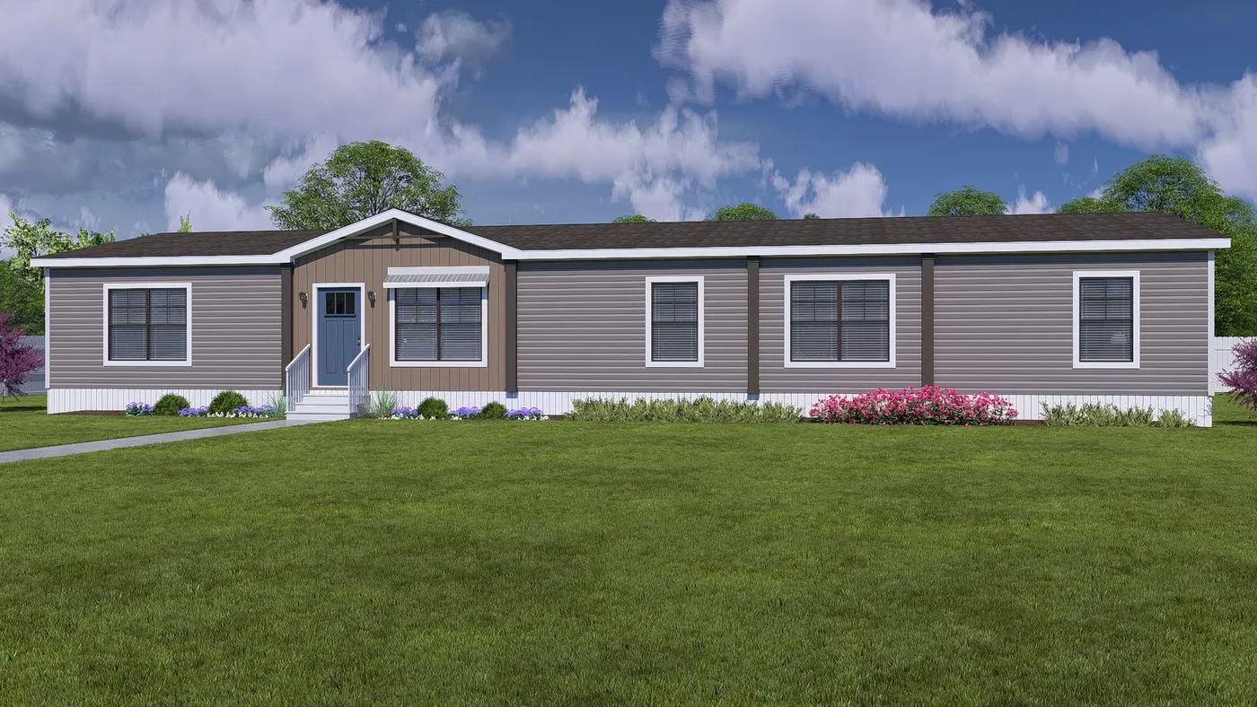 A single-story, gray manufactured home with white trim, multiple windows, a front door with steps, and a well-kept lawn with shrubs and flowers.