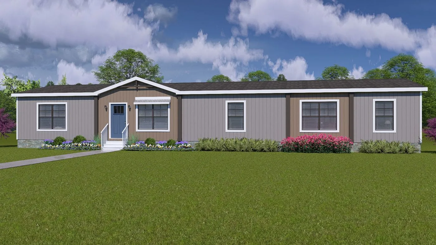 A single-story manufactured home with gray siding, a blue front door, several large windows, and landscaping in the front yard under a partly cloudy sky.