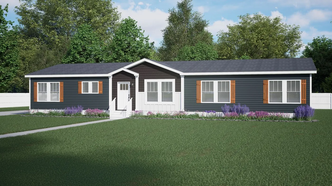 Single-story dark blue manufactured home with white trim, brown shutters, front porch steps, and landscaped yard with grass and shrubs, set against a backdrop of trees.